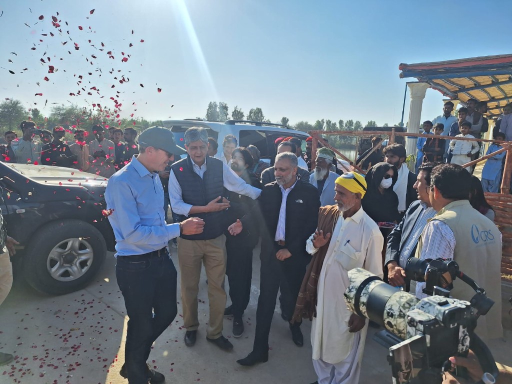 Community welcome during a field visit in rural Pakistan